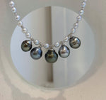 Close view of the central Tahitian pearl with dark metallic overtones.