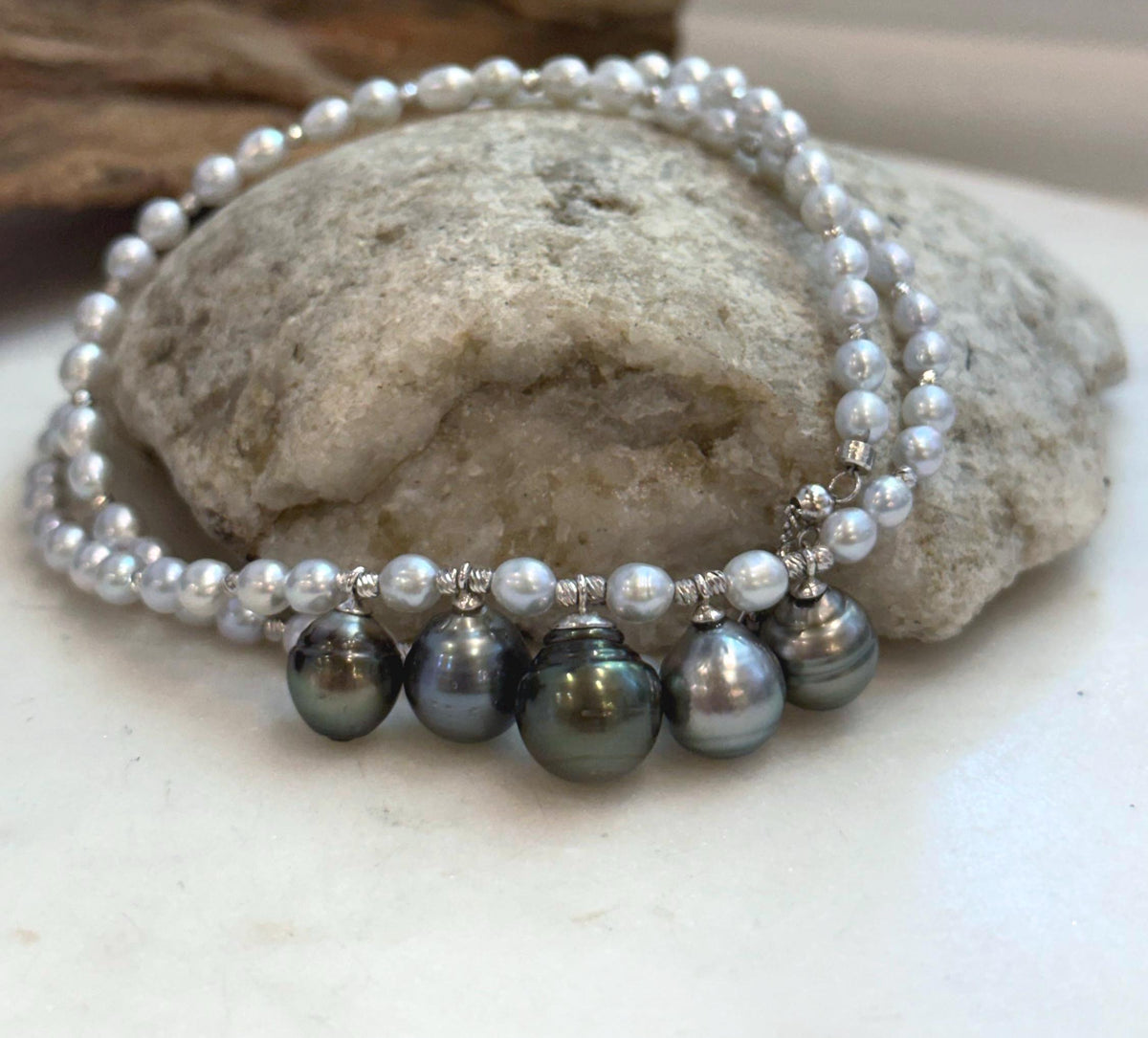 Tahitian pearl drops showing their individual shapes, colors and natural surface details.
