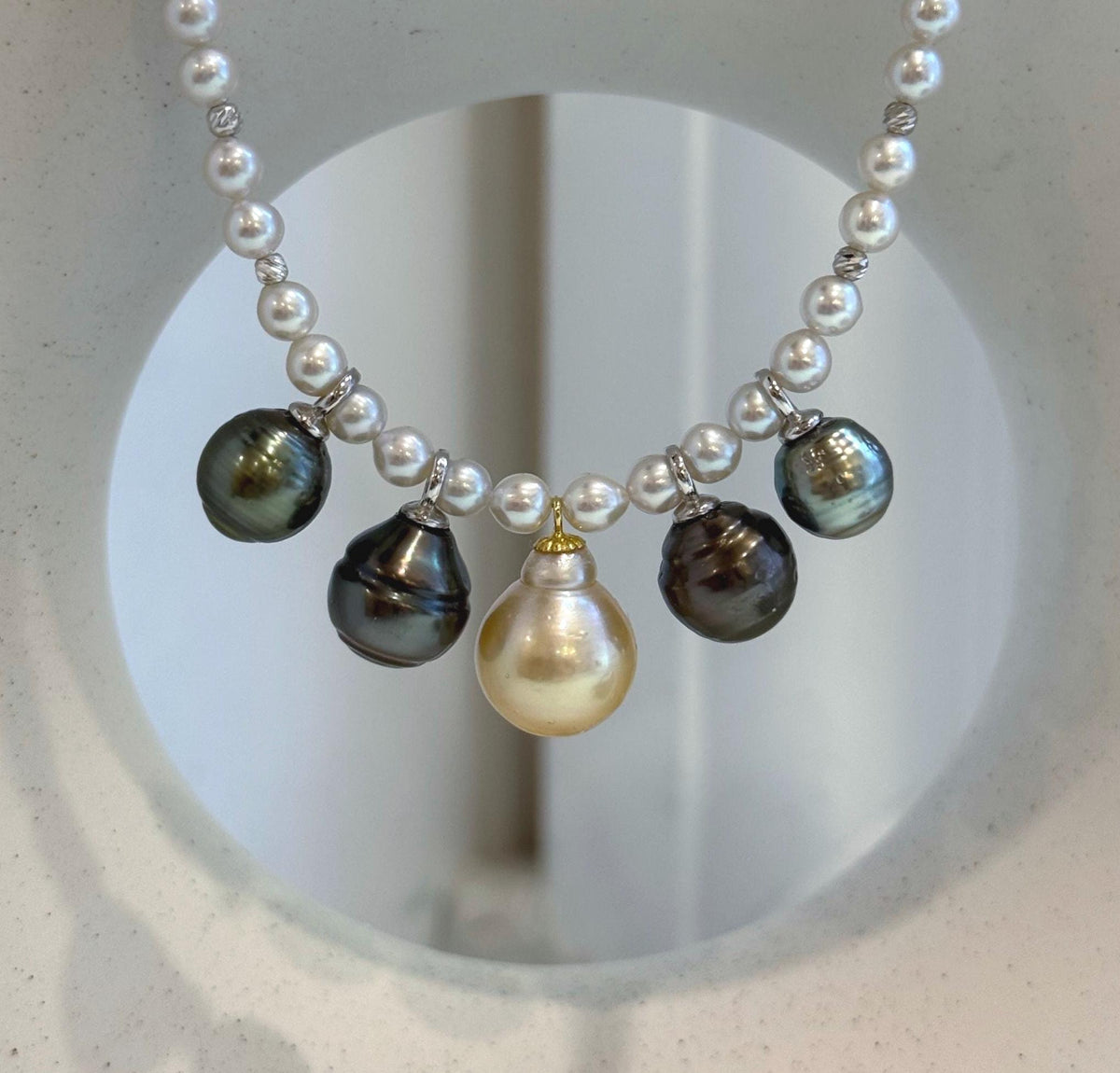White pearl strand necklace with five dangling South Sea ocean pearls.