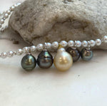 Side view of the pearl drop necklace on a jewelry display.