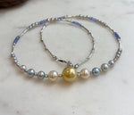 Saltwater pearl necklace with a golden center pearl and blue tanzanite beads.