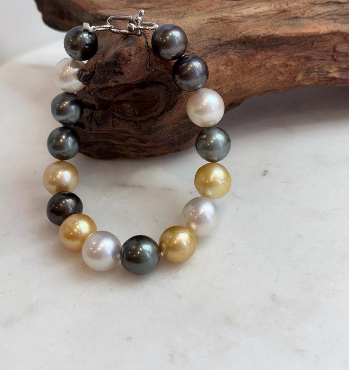 Ocean pearl bracelet arranged on a pale background.