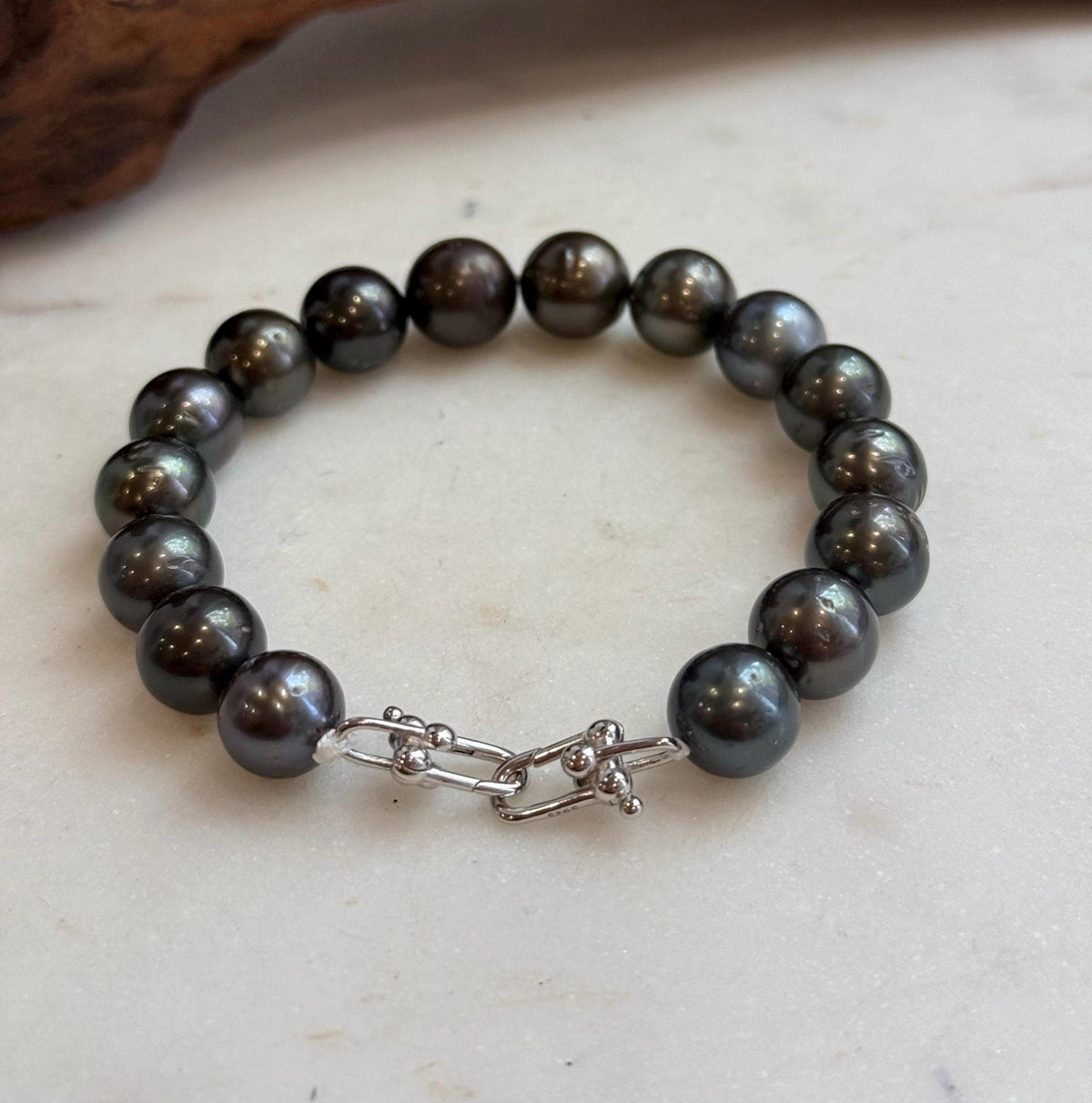 Hunter green Tahitian pearls with lustrous surfaces.