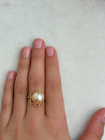 Vintage-style floral lace ring featuring a lustrous golden South Sea pearl and an adjustable band.
