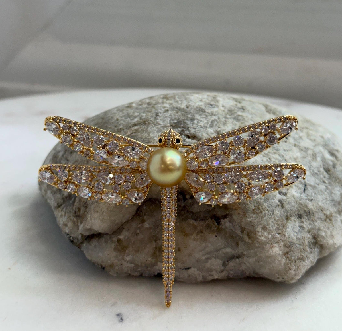 Genuine South Sea pearl with extreme mirror luster featured in a two-in-one dragonfly brooch pendant.