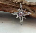 Detail of the star design surrounding the genuine freshwater pearl.