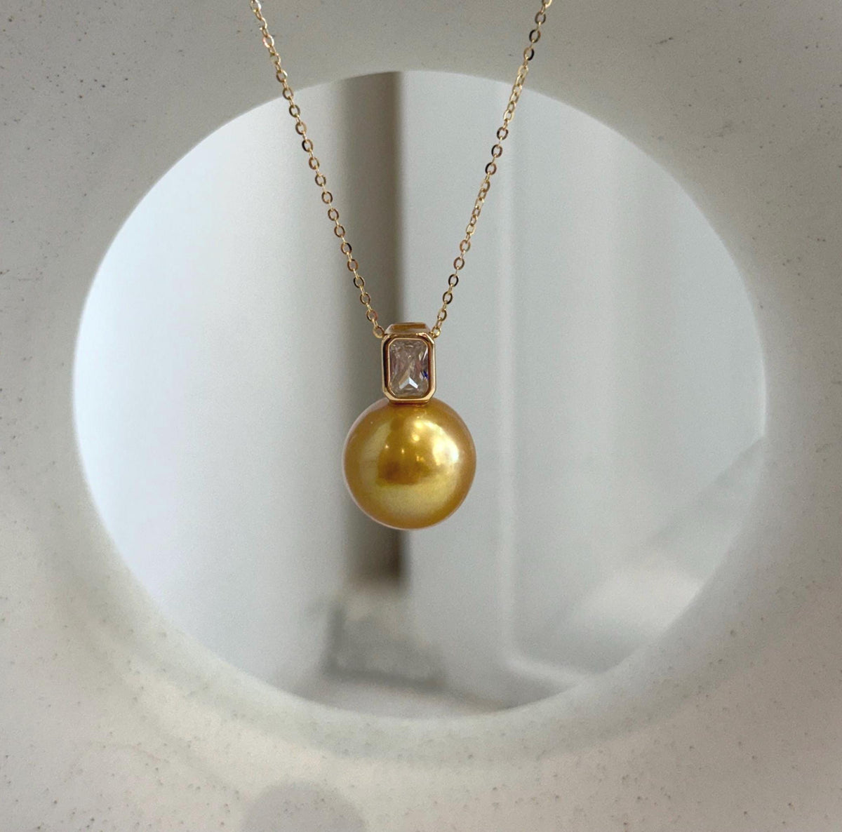 Minimalist necklace featuring a large golden Edison freshwater pearl.
