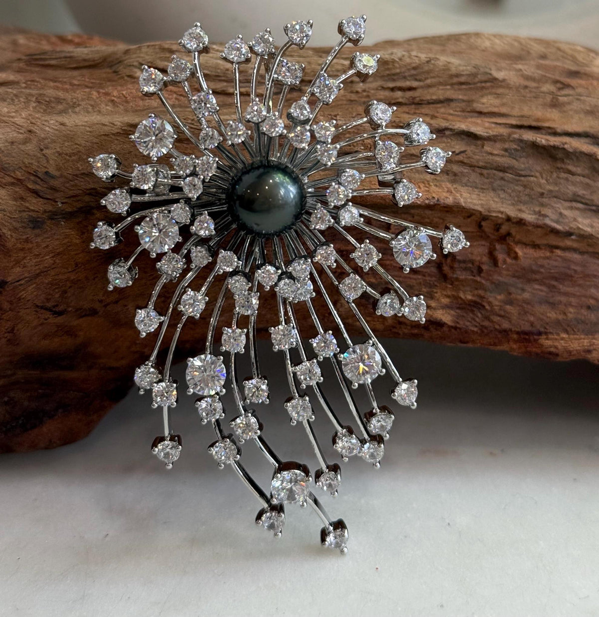 Fireworks-inspired pearl jewelry designed to be worn as a brooch or pendant.