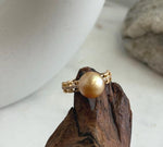 Vintage-inspired gold-plated ring with a lustrous golden pearl centerpiece.