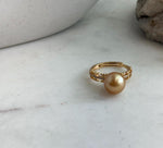 Warm golden South Sea pearl contrasted with the textured ring setting.