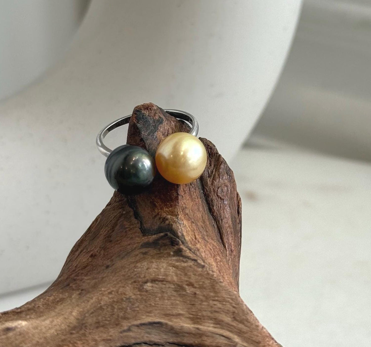 Adjustable silver ring with a golden South Sea pearl and a dark Tahitian pearl.