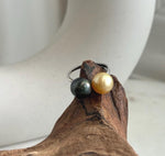 South Sea and Tahitian pearls set at the ends of a slim sterling silver band.