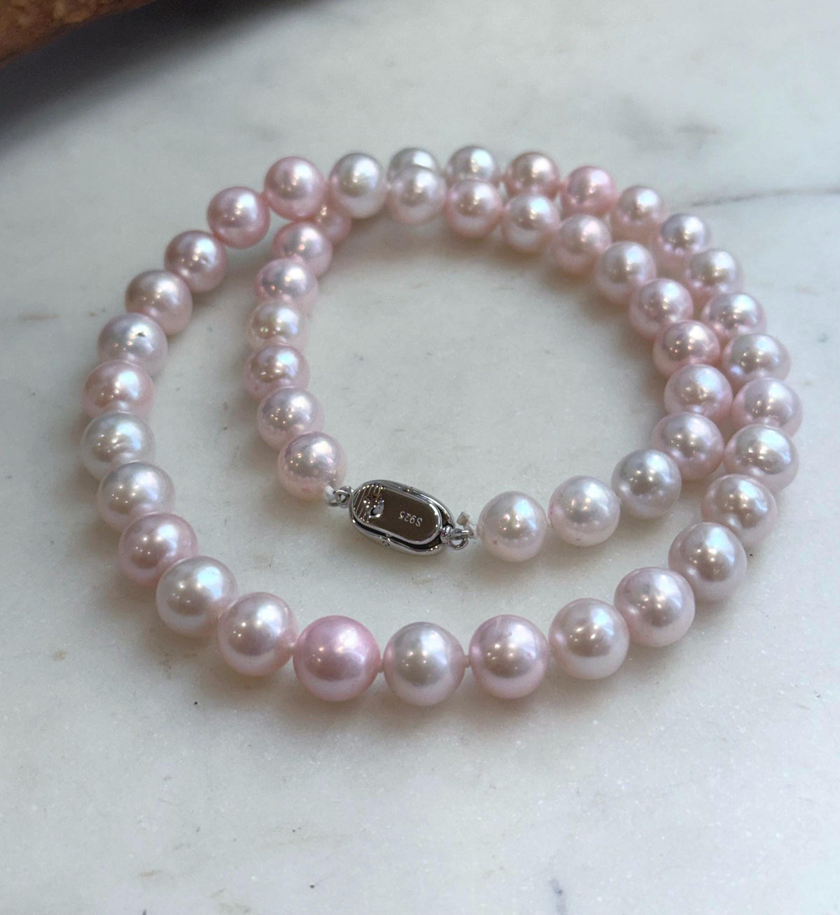 Hand-knotted necklace featuring 50 genuine pale pink freshwater pearls.