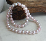 Pale pink pearl necklace finished with a sterling silver clasp.