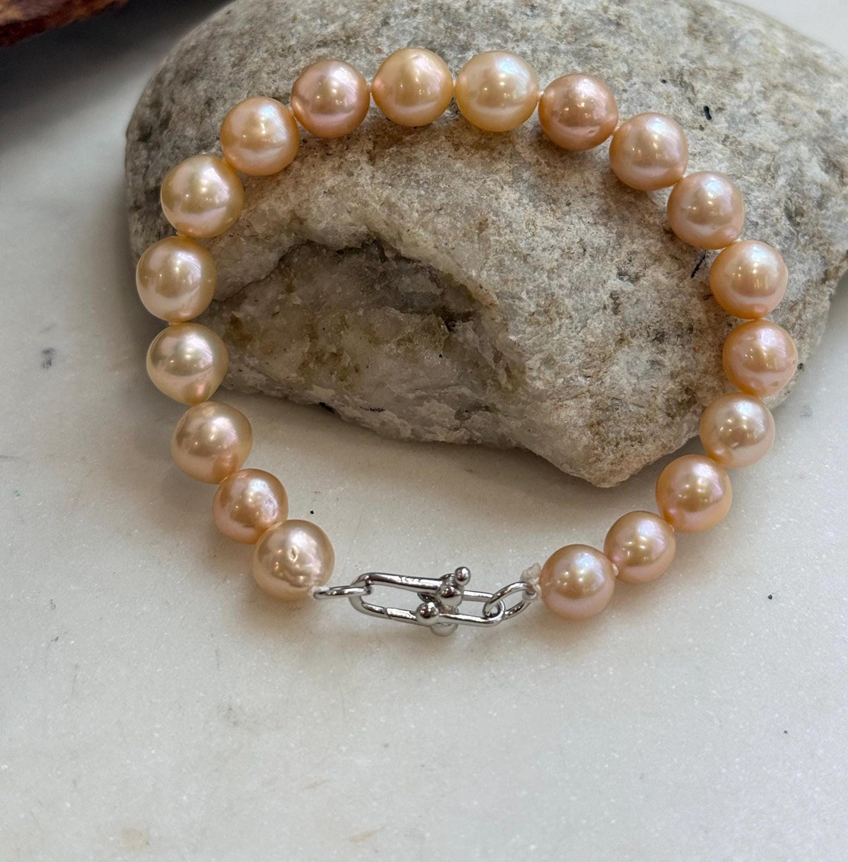Lustrous peach freshwater pearls with a silver clasp