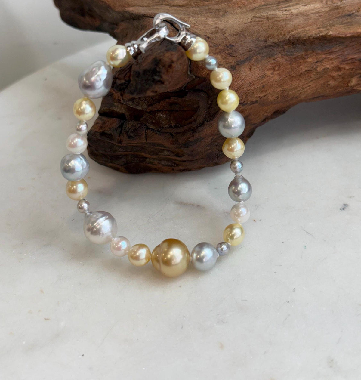 Saltwater pearl bracelet combining smaller and larger pearls in varied colors.