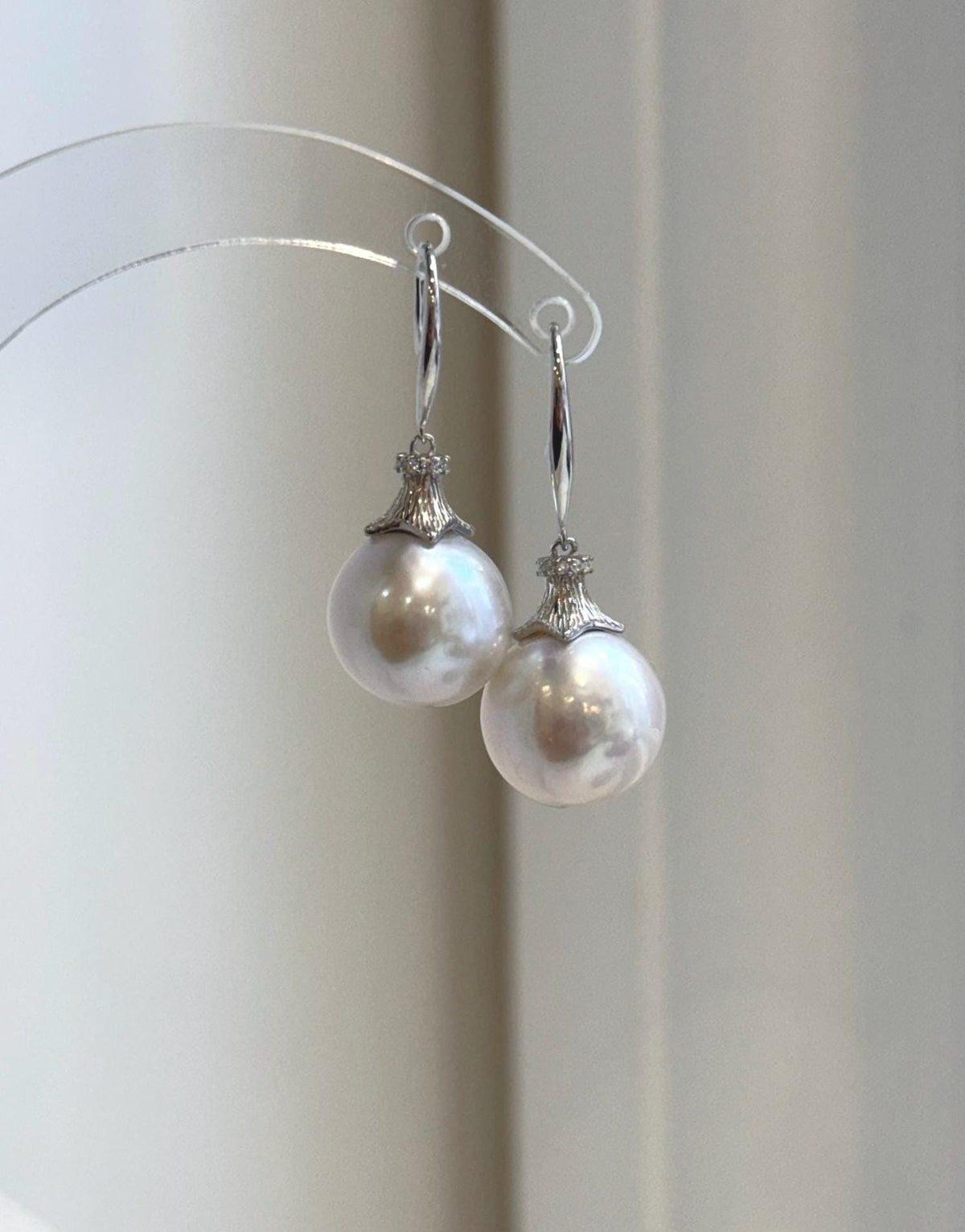 Close-up of white Edison pearls with soft rosy overtones and reflective luster.
