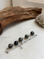 Tahitian pearl station bracelet paired with a second chain of small silver beads.