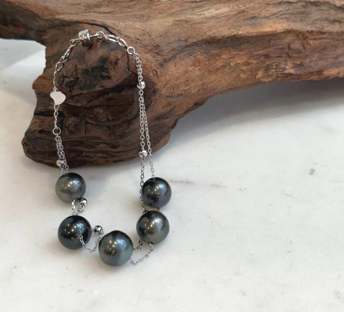 Tahitian pearl double chain bracelet with five dark pearls and sterling silver bead accents.