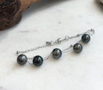 Adjustable Tahitian pearl bracelet with a silver extender chain and small heart charm.