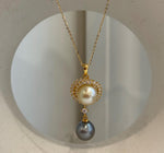Two genuine saltwater pearls in a vertical pendant with gold-tone sterling silver details.