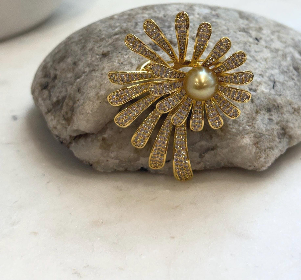 Golden South Sea pearl at the center of a sparkling floral design