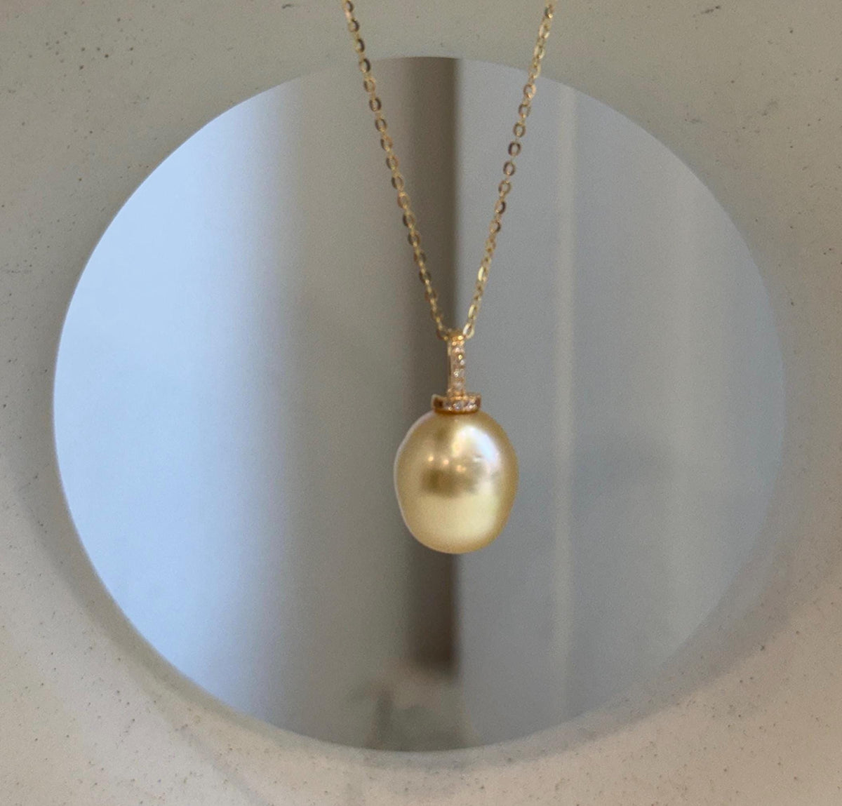 Golden iridescent South Sea pearl drop pendant with an S925 sterling silver setting.