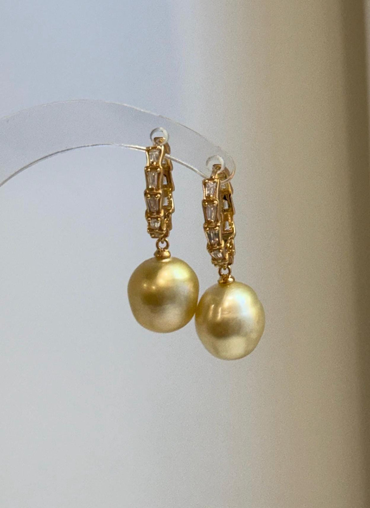 Front view of 11.1mm golden South Sea pearl hoop earrings.