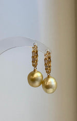 Elegant gold-tone hoop earrings with genuine saltwater pearl drops.