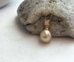 Golden South Sea pearl pendant with mirror luster and a silver setting.