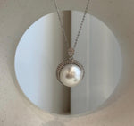 White Australian South Sea pearl with a highly reflective surface in a silver pendant.