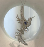 Bird-shaped pearl brooch pendant shown as a two-in-one jewelry design