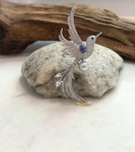 Close-up of the lustrous Akoya pearl set in a bird brooch pendant
