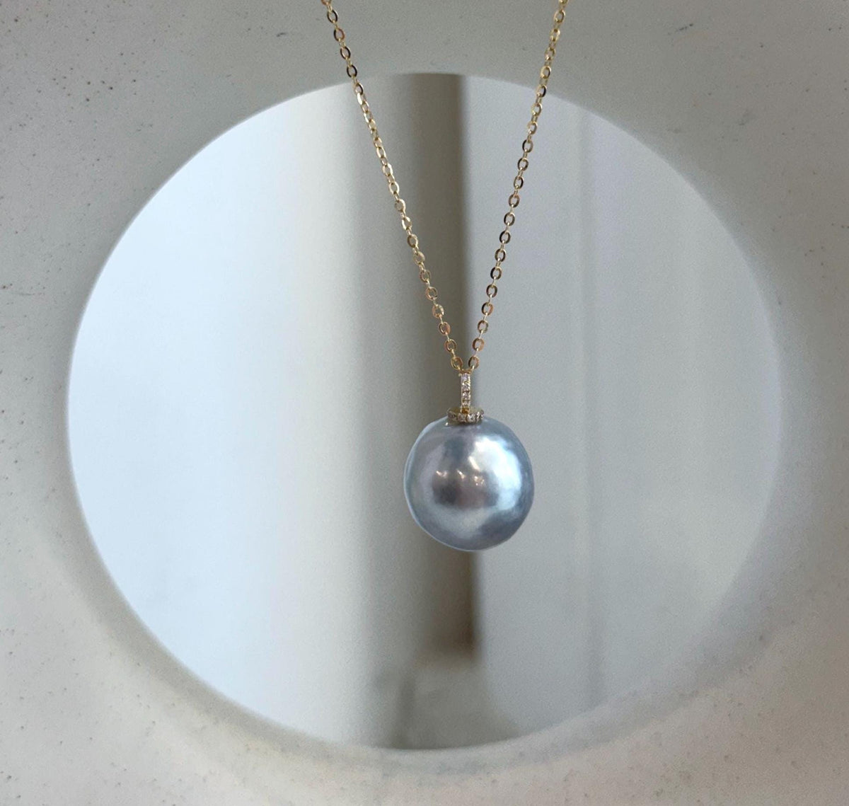Silver blue South Sea pearl pendant with mirror luster, moissanite accents and an 18K solid gold setting.