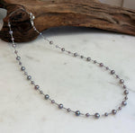 Close-up of genuine freshwater pearls showing purple and rose pink tones and mirror-like luster