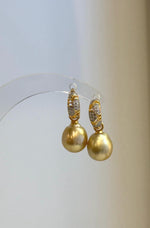 Close-up of both pearl drops and the decorative sparkling hoop details.