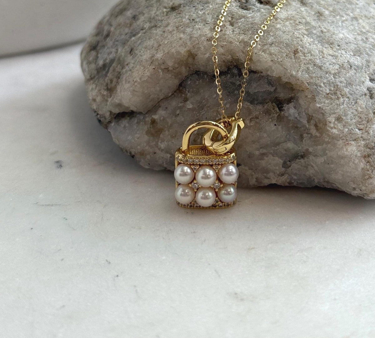 Akoya pearl pendant necklace featuring a miniature purse design