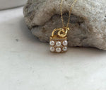 Ivory pearl and gold-tone pendant necklace with a decorative handbag motif