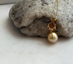 Golden South Sea pearl with mirror luster in a sterling silver pendant setting.