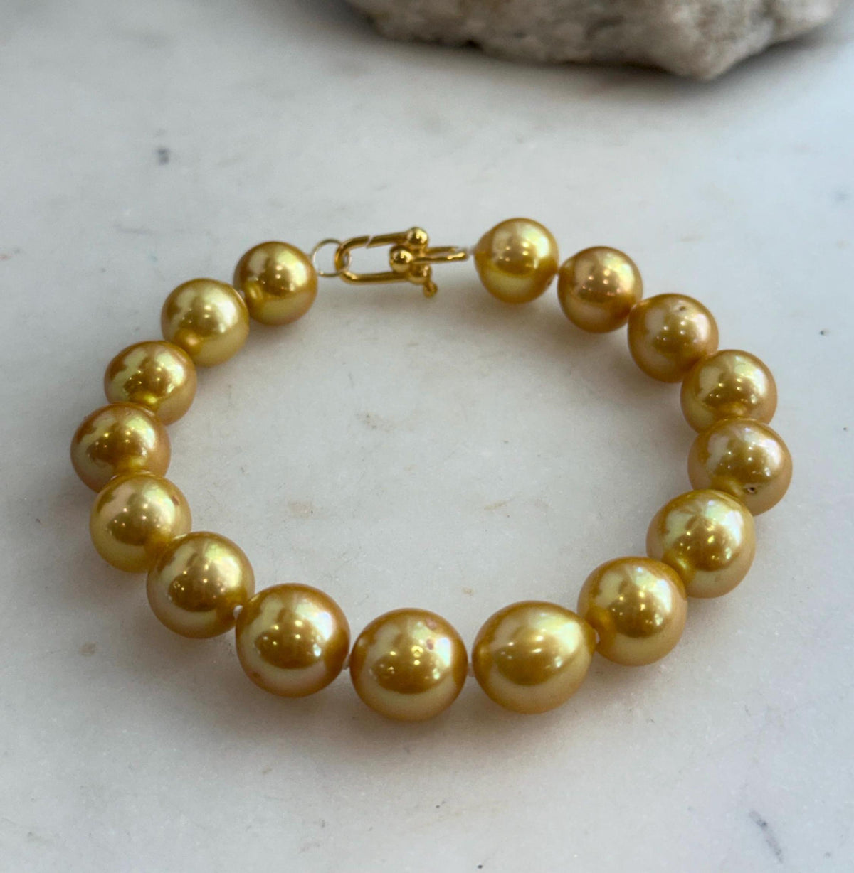 Close view of the pearls along the bracelet, showing their individual shapes and luster.