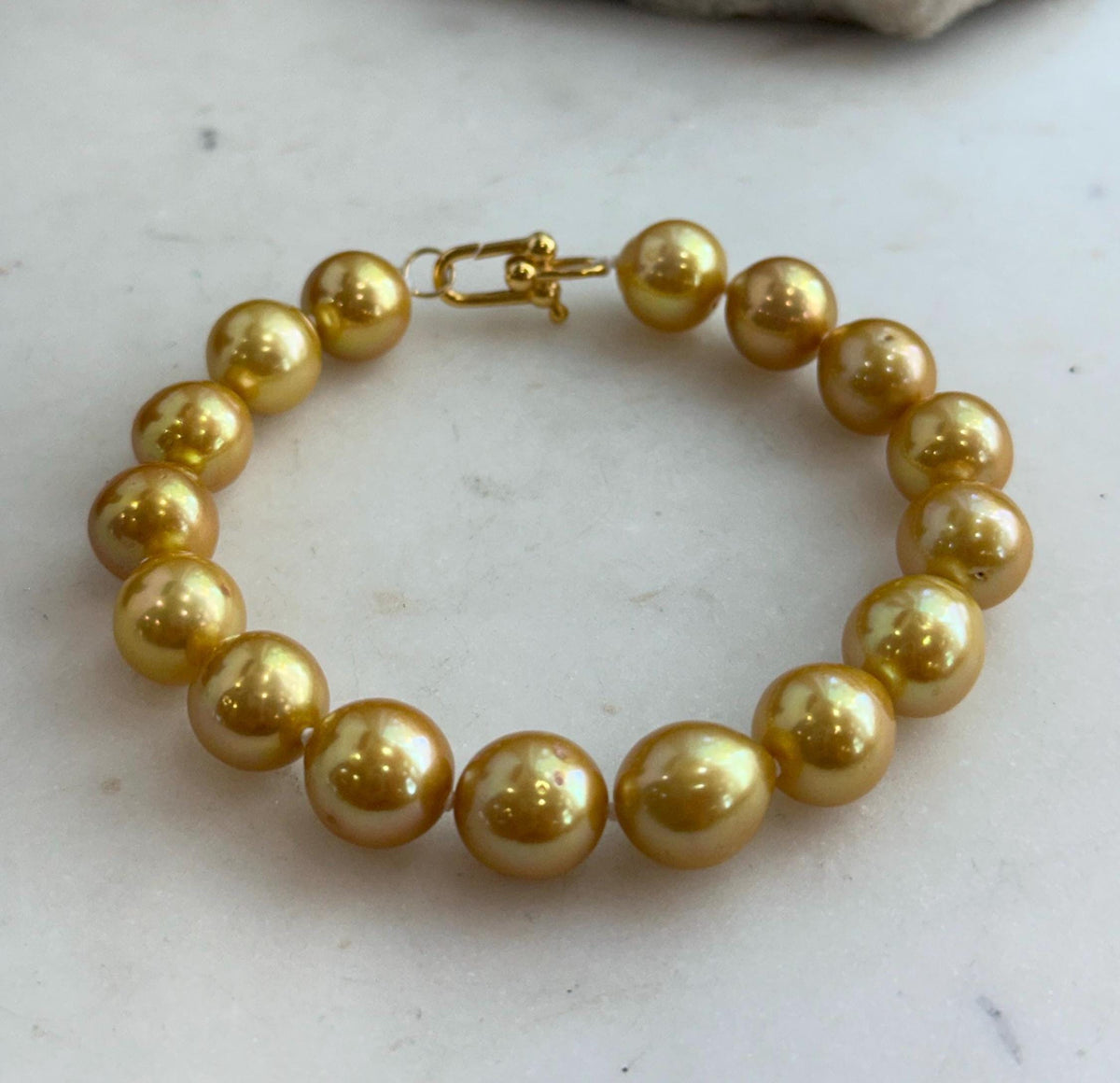 Elegant bracelet featuring 16 golden Edison freshwater pearls in a single strand.