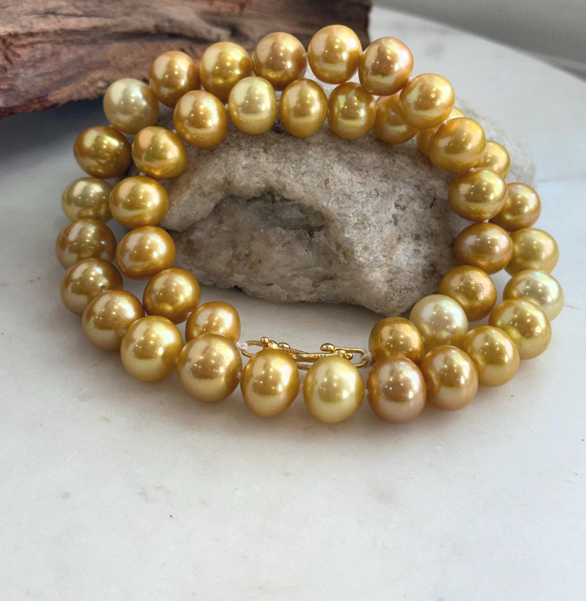 Hand-knotted strand of golden Edison pearls with bright mirror luster.