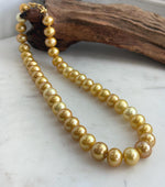 Classic single-strand necklace made with 41 golden Edison pearls.