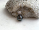 Hunter green saltwater pearl necklace with a crystal-decorated sterling silver pendant.