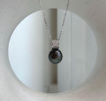 Genuine Tahitian pearl pendant combining mirror luster with crystal-accented silver.