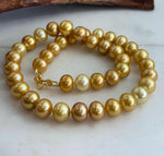 Golden Edison pearl necklace with a graceful drape and brilliant reflective luster.