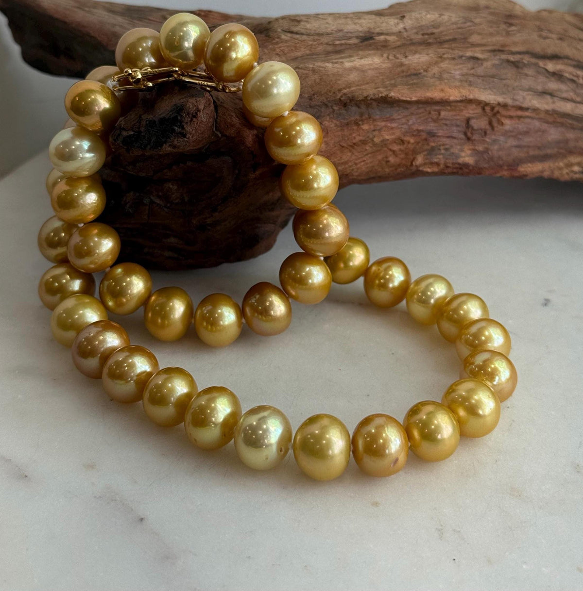 Genuine freshwater Edison pearls in warm golden tones, individually knotted into a necklace.