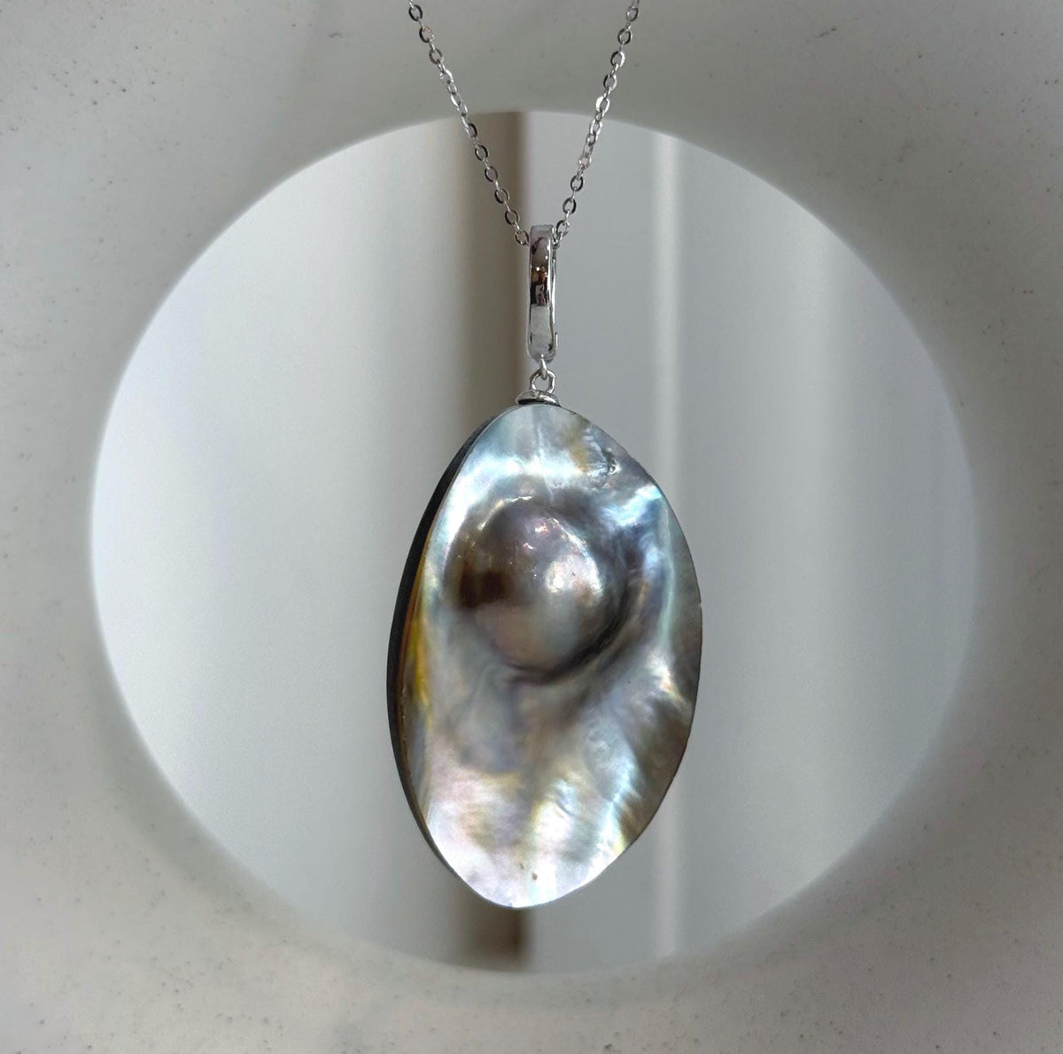 Ocean Mabe pearl framed by a polished sterling silver setting