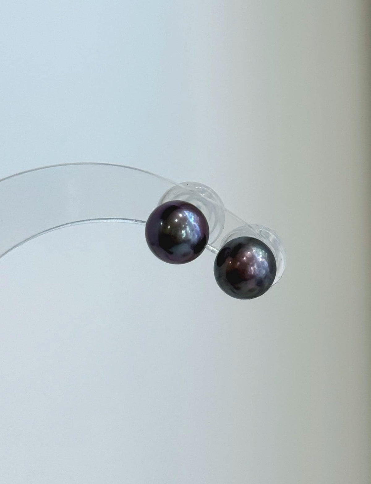 Mirror-luster plum pearls in a minimalist stud earring design.