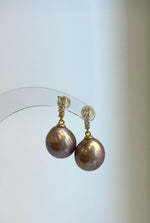 Genuine freshwater pearl earrings featuring rose mauve tones and sterling silver.